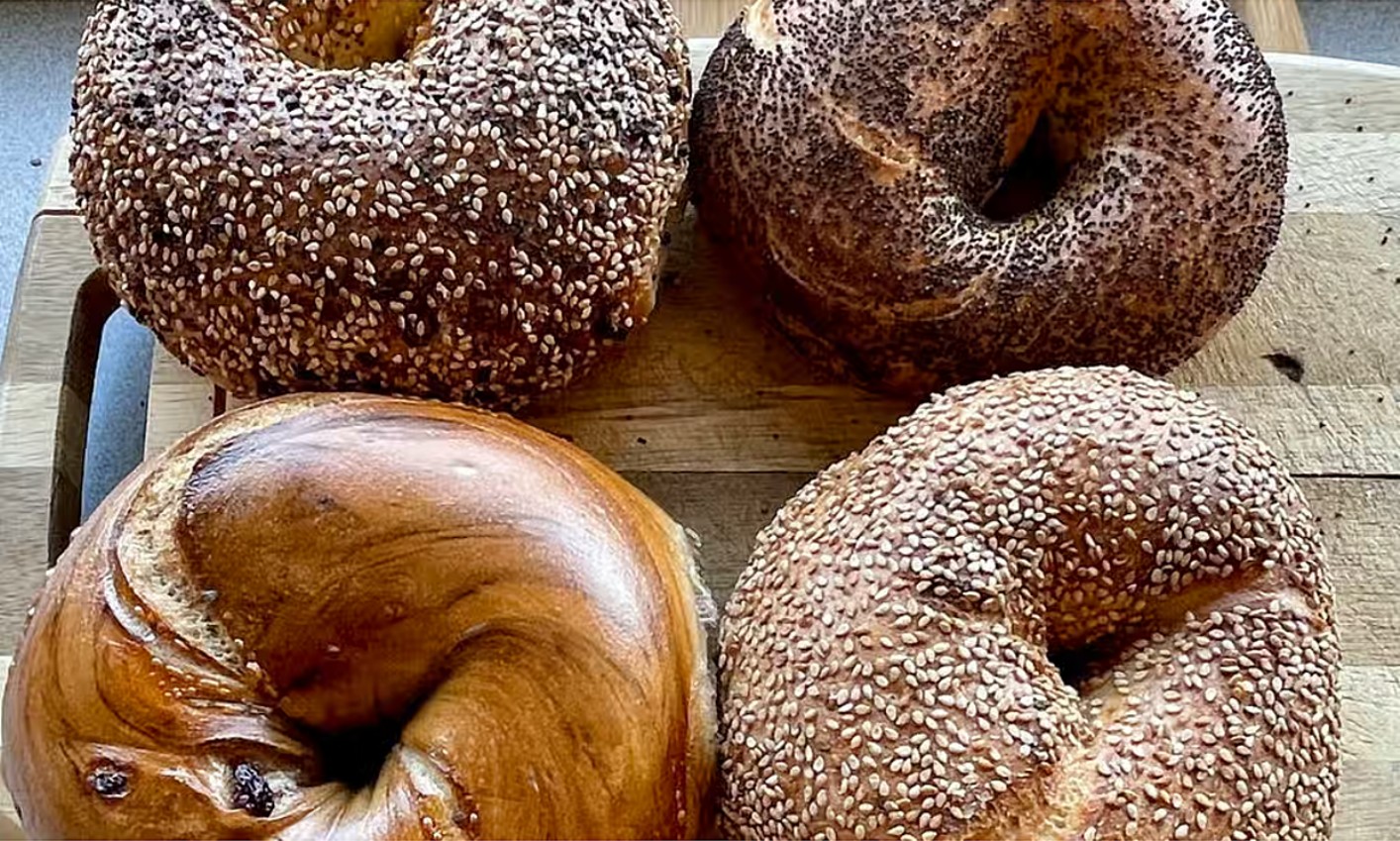 Four bagels on a wooden board at Brook Street